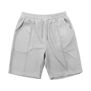Macro view of men's casual grey waffle-knit shorts featuring elastic drawstring waist