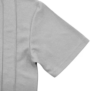 Close-up of the sleeve texture and seam detail of a gray waffle knit shirt