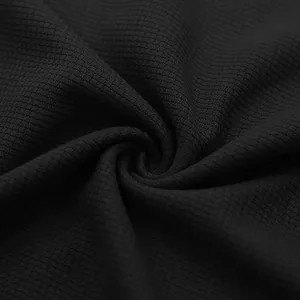 Macro view showing the detailed texture of black waffle knit fabric for men's summer set