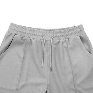 Close-up detail of mens gray waffle knit shorts showing waistband and drawstring.