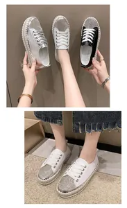 Detail of women's white platform sneakers featuring sparkling rhinestone toe cap design