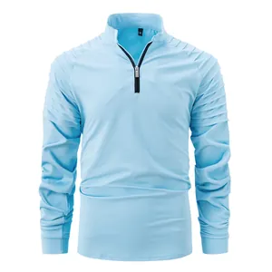 Detailed view of a light blue men's quarter-zip athletic pullover with pleated shoulders