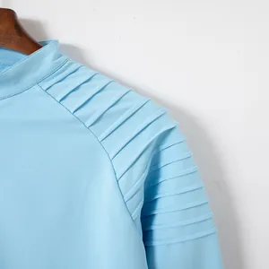 Detail shot of men's sky blue athletic zipper shirt with pleated shoulder texture