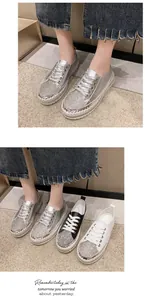 Detail view of women's rhinestone platform sneakers in silver, black and white