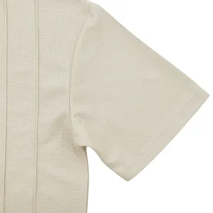 Detailed close-up showing the high-quality waffle knit texture of this beige men's shirt.