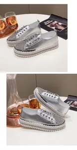 Detailed view of silver rhinestone platform sneakers featuring thick soles and lace-up design