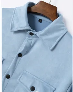 Detailed macro shot of a light blue men's suede jacket showing texture and black buttons