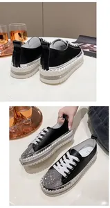 Detail of black women's platform sneakers with rhinestones and woven edges