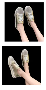 Women's elegant gold platform sneakers featuring rhinestone toes and lace-up design.