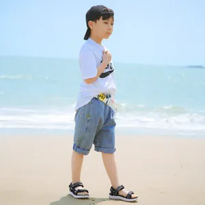 Durable and lightweight boys' casual black beach sandals shown on a sunny beach background