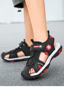Detailed side view of children's breathable closed-toe sandals with red accents