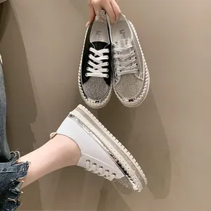 Fashionable women's platform sneakers featuring sparkling rhinestone details and lace-up closure