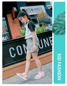 Girl walking in pink open-toe summer sandals with soft soles on a trendy urban street.