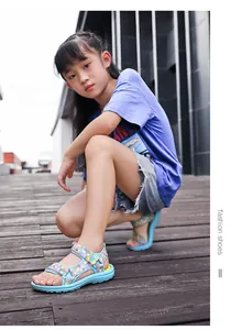 Girl's woven sandals with butterfly detail and soft sole in a lifestyle setting