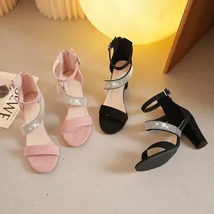 Elegant chunky heel sandals with rhinestone cross straps in pink and black suede finish.