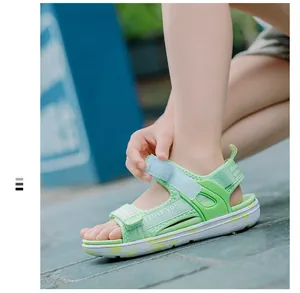 Close-up detail of girls' lime green summer sandals with 'I LOVE YOU' velcro straps