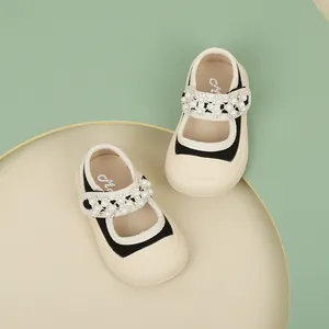 Elegant black toddler Mary Jane shoes with pearl floral strap on beige sole