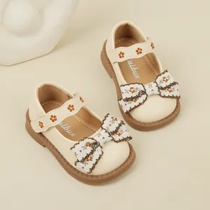 Cream baby girl Mary Jane shoes with floral bow decoration and soft walking sole
