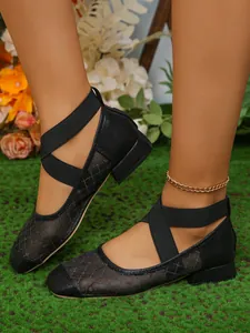 Dettaglio scarpe Mary Jane in mesh nero con cinturini incrociati e punta quadrata alla moda.