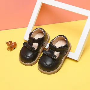 Dark brown leather toddler girl princess shoes featuring a bow accent and velcro strap