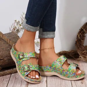 Close-up of women's colorful grid slippers featuring double vintage metal buckles and wedge soles.