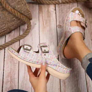 Detailed close-up of colorful checkered women's wedge sandals with metal buckles