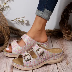 Detailed view of women's wedge sandals with colorful woven grid straps and metal buckles.