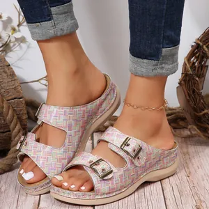 Detailed view of women's wedge sandals with double metal buckles and colorful plaid pattern