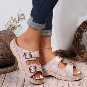 Close-up view of stylish women's plaid wedge sandals with double metal buckle details