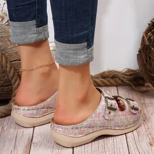 Back view detail of colorful plaid wedge sandals with decorative metal buckles