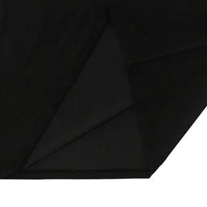 Close-up detail of the hem and side slit stitching on a black quick-dry men's polo shirt.