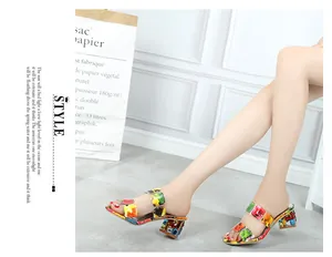 Dettaglio di eleganti sabot da donna con strass colorati e tacco largo alla moda