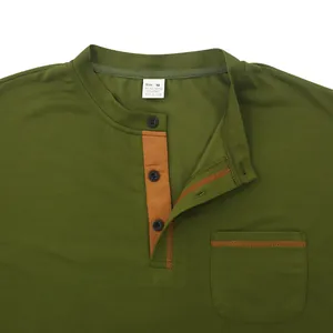 Detailed close-up of olive green men's quick-dry Polo shirt with orange contrast stitching