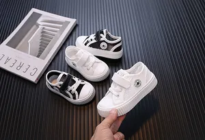 Close-up of breathable mesh kids sneakers in black and white styles