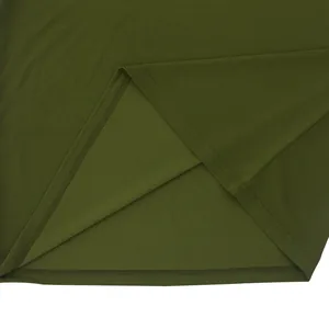 Macro detail view showing high-quality quick-dry fabric on olive green men's polo shirt