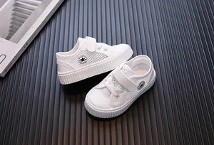 Top view of stylish white breathable mesh children's sneakers with Velcro straps