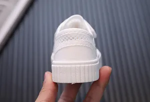 Close-up detail of breathable white mesh heel and durable rubber sole for kids shoes