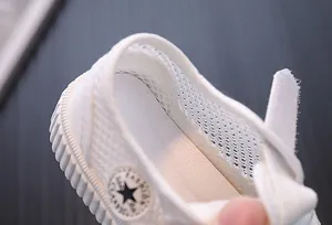 Macro detail of breathable mesh fabric and interior of white toddler sneakers shoes