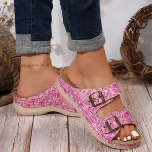 Detailed view of women's pink plaid wedge sandals with adjustable metal buckles.
