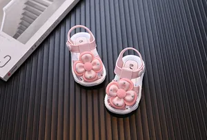 Pink toddler girl sandals featuring large decorative flowers and silver studded details.