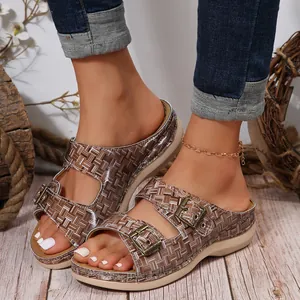 Detailed view of women's wedge sandals with decorative double buckles and plaid pattern.