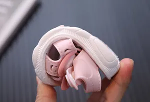 Demonstration of the flexible and soft sole on pink closed-toe toddler girl sandals