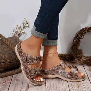 Close-up of double adjustable metal buckles and woven plaid texture on women's wedge slides