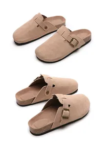 Close-up detail view of beige suede cork clogs featuring adjustable bronze buckle straps