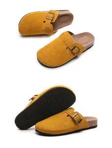 Detailed view of yellow suede clogs with adjustable buckle and cork style footbed