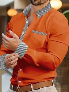 Close-up detail of a bright orange men's casual shirt featuring houndstooth pattern accents