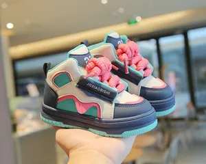 Primer plano de zapatillas altas de dopamina coloridas para niños con cordones rosas