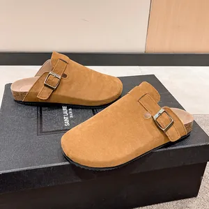 Macro detail of tan suede mule slippers with cork soles and adjustable straps
