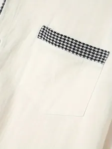 Close-up of men's casual shirt pocket with black and white houndstooth trim detail