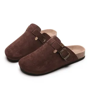 Casual dark brown suede clogs with cork soles and adjustable buckle straps for unisex wear.